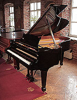 A 1969, Steinway Model O grand piano with a black case and spade legs. 