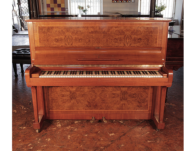 Reconditioned, 1939, Steinway Model V upright piano for sale with a walnut case and brass fittings. Piano features mirrored, burr walnut panels. Piano has an eighty-eight note keyboard and two pedals. .