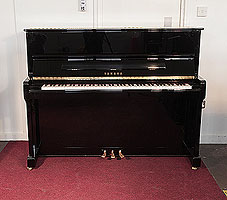 A 2007, Yamaha P121G upright piano for sale with a black case and brass fittings 