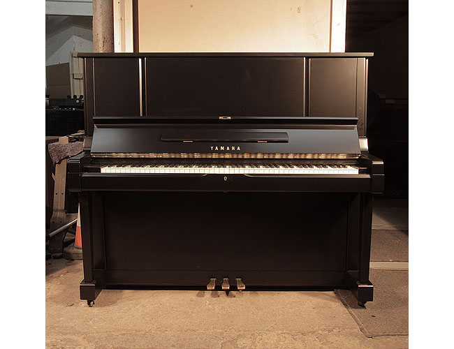 Reconditioned, 1981, Yamaha YUX upright piano for sale with a satin, black case and brass fittings. Piano has an eighty-eight note keyboard and three pedals. 