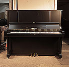 Piano for sale.  Reconditioned 1981, Yamaha YUX upright piano for sale with a satin, black case and brass fittings. Piano has an eighty-eight note keyboard and three pedals. 