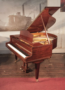 A 1932, Bluthner baby grand piano for sale with a mahogany case and square, tapered legs Piano has an eighty-eight note keyboard and a three-pedal lyre..