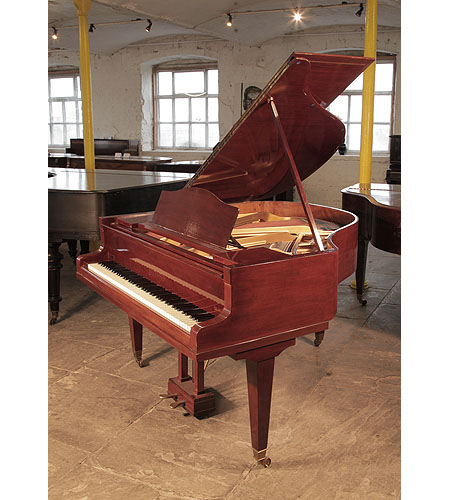 A 1932, Bluthner baby grand piano for sale with a mahogany case and square, tapered legs. Piano has an eighty-eight note keyboard and a two-pedal lyre.