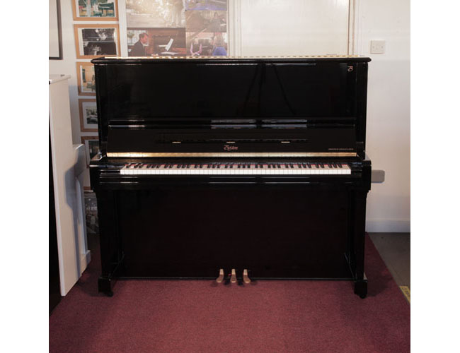 Reconditioned, 2010, Boston UP-132 upright piano for sale with a black case and brass fittings. Piano has an eighty-eight note keyboard and three pedals. 