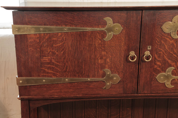Broadwood oak cabinet with studded brass strap hinges.