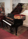 Piano for sale. Pre-owned, Brodmann BG-187 grand piano for sale with a black case and spade legs. Piano has an eighty-eight note keyboard and a three-pedal lyre. 