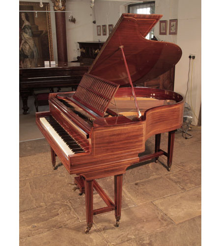 A 1910, Collard and Collard baby grand piano with a mahogany case and gate legs attached with a cross stretcher. Cabinet inlaid with satinwood stringing accents. 