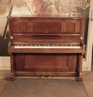 Piano for sale. Reconditioned, 1924, Feurich upright piano with a polished, mahogany case. Piano has an eighty-eight note keyboard and two pedals