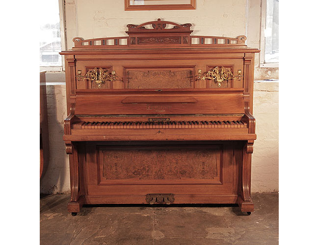 Reconditioned, 1908, Feurich upright piano with a walnut case, burr walnut panels and an unusual walnut keyboard Piano has an eighty-five note keyboard and two pedals. 