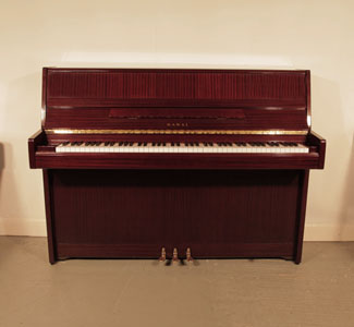 A 1988, Kawai CE10N upright piano for sale with a mahogany case and brass fittings. Piano has an eighty-eight note keyboard and three pedals.  