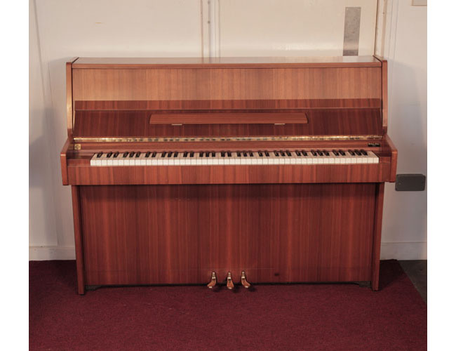 Pre-owned, 1981, Kawai CE7N upright piano for sale with a satin, walnut case and brass fittings. Piano has an eighty-eight note keyboard and three pedals  