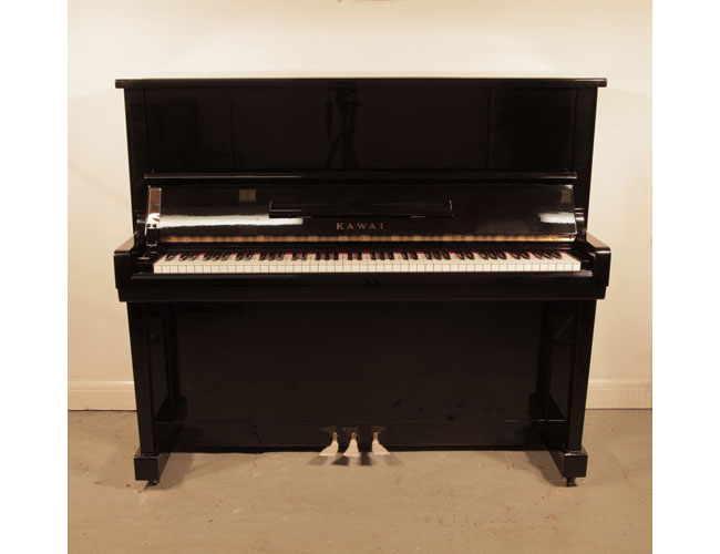  Reconditioned, 1964, Kawai K20 upright piano with a black case and polyester finish. Piano has an eighty-eight note keyboard and three pedals.