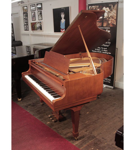 Reconditioned, 1978, Kawai KG-2C grand piano with a with a polished, walnut case and spade legs.  Piano has an eighty-eight note keyboard and a three-pedal lyre. 