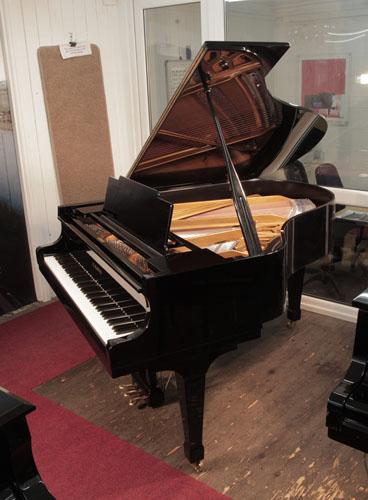 Piano for sale. Reconditioned 1976, Kawai KG-2C grand piano for sale with a black case and spade legs. Piano has an eighty-eight note keyboard and a three-pedal lyre.  
