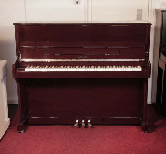 A 2016, Ritmuller upright piano for sale with a mahogany case and slow fall mechanism .