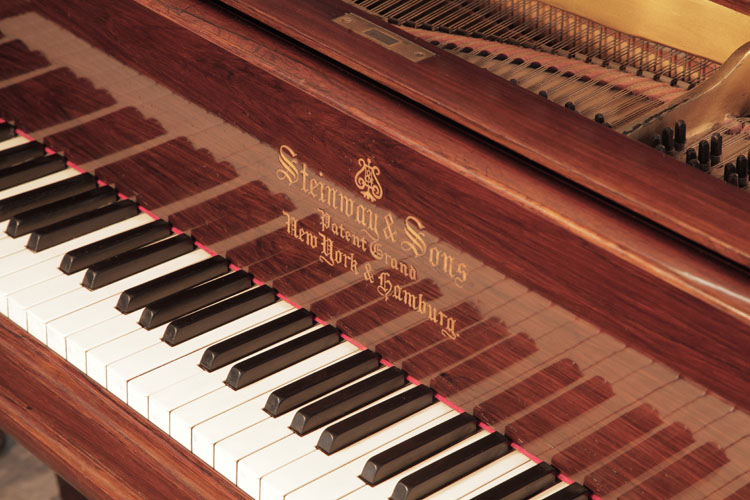 Steinway Model A piano manufacturers logo inlaid on fall. We are looking for Steinway pianos any age or condition.