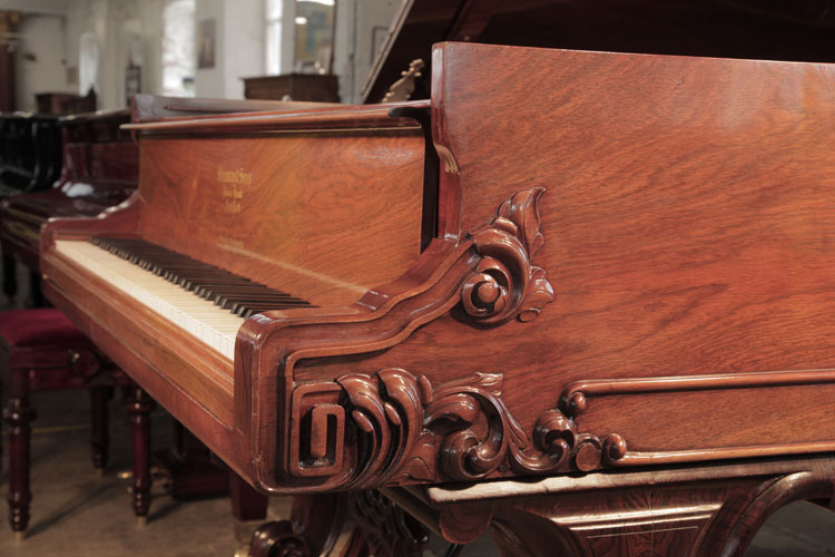 Steinway Style 1 grand  piano cheek features a carved, Classical meander and acanthus in high relief.
