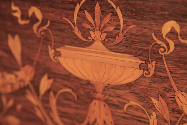 Steinway inlay detail featuring a central urn 