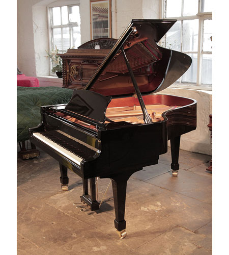 Brand new, Toyama TC-187 grand piano for sale with a black case and spade legs.  Piano has an eighty-eight note keyboard and a three-pedal piano lyre. 