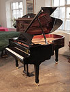 Piano for sale. Brand new, Toyama TC-187 grand piano for sale with a black case and spade legs.