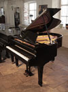 Piano for sale. Reconditioned, 1975, Yamaha G2 grand piano for sale with a black case and spade legs. Piano has an eighty-eight note keyboard and a two-pedal lyre..