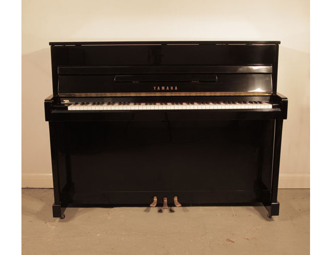 Reconditioned, 1972, Yamaha LX-110 upright piano for sale with a black case and brass fittings. Piano has an eighty-eight note keyboard and three pedals.  