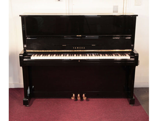 Reconditioned, 1974, Yamaha U1 upright piano with a black case and polyester finish. Piano has an eighty-eight note keyboard and three pedals. .