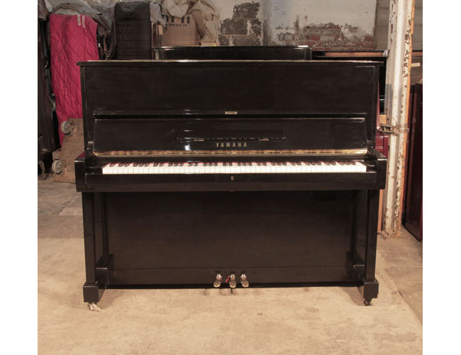 Reconditioned, 1994, Yamaha U1 upright piano with a black case and polyester finish. Piano has an eighty-eight note keyboard and three pedals.
