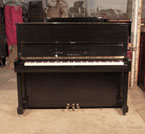 Piano for sale. Reconditioned, 1994, Yamaha U1 upright piano with a black case and polyester finish. Piano has an eighty-eight note keyboard and three pedals.