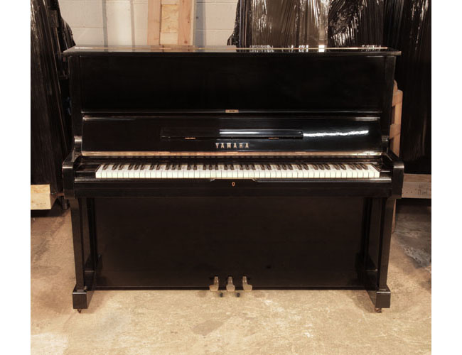 Reconditioned, 1973, Yamaha U1 upright piano with a black case and polyester finish. Piano has an eighty-eight note keyboard and three pedals.