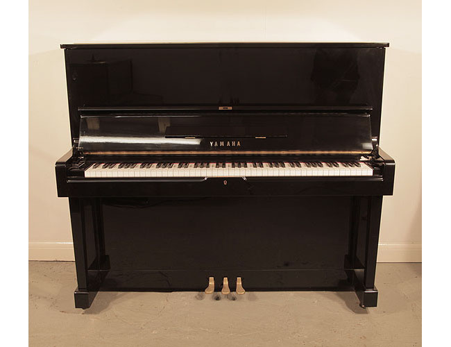  Reconditioned, 1965, Yamaha U2 upright piano with a black case and polyester finish. Piano has an eighty-eight note keyboard and three pedals.