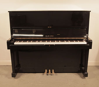 Reconditioned, 1965, Yamaha U2 upright piano with a black case and polyester finish. Piano has an eighty-eight note keyboard and three pedals. 