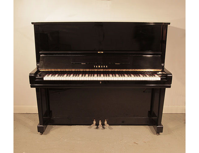 Pre-owned, 1968, Yamaha U3 upright piano for sale with a black case and brass fittings. Piano has an eighty-eight note keyboard and three pedals. 