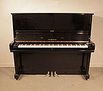 Piano for sale. Reconditioned, 1968, Yamaha U3 upright piano for sale with a black case and brass fittings. Piano has an eighty-eight note keyboard and three pedals.  