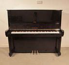Piano for sale. Reconditioned,   Yamaha U5 upright piano with a black case and polyester finish. Piano has an eighty-eight note keyboard and three pedals.  
