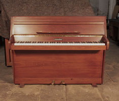 Zender upright piano with a polished, walnut case and brass fittings