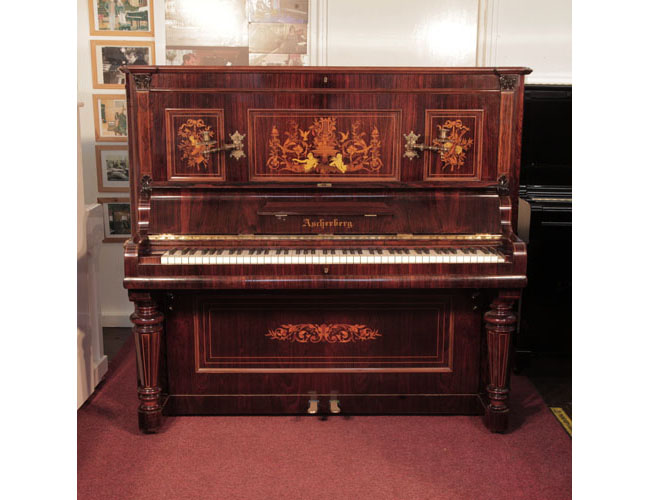 Restored, 1890, Ascherburg upright piano for sale with a rosewood case and turned, faceted legs. Cabinet features panels inlaid with a Neoclassical design in a variety of woods