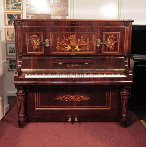 Restored, 1890, Ascherburg upright piano with a rosewood case and turned, faceted legs. Cabinet inlaid with a Neoclassical design in a variety of woods