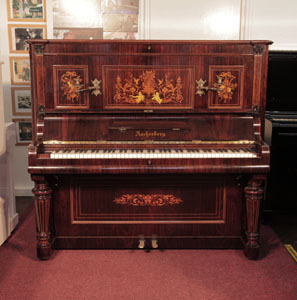 Restored, Ascherburg upright piano with a rosewood case and turned, faceted legs. Cabinet inlaid with a Neoclassical design in a variety of woods