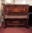 Piano for sale. Restored, Ascherburg upright piano with a rosewood case and turned, faceted legs. Cabinet inlaid with a Neoclassical design in a variety of woods. Piano has an eighty-five note keyboard and and two pedals.