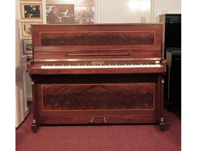 Reconditioned, 1988, Bentley upright piano with a mahogany case with flame mahogany panels bordered with satinwood stringing. 