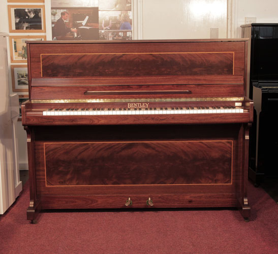 Reconditioned,  1988, Bentley upright piano with a mahogany case with flame mahogany panels bordered with satinwood stringing.