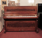 Piano for sale.  Reconditioned, 1988, Bentley upright piano with a mahogany case with flame mahogany panels bordered with satinwood stringing