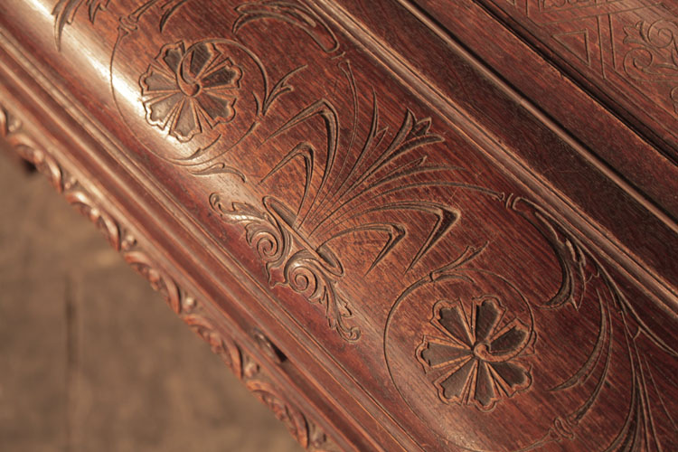 Francke piano fall carved with stylised anthemion and hibiscus flowers