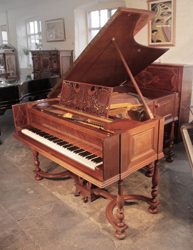 A 1912, Schiedmayer grand piano for sale with a harpsichord style mahogany cabinet, arts and crafts openwork music desk and baluster legs on a cross stretcher