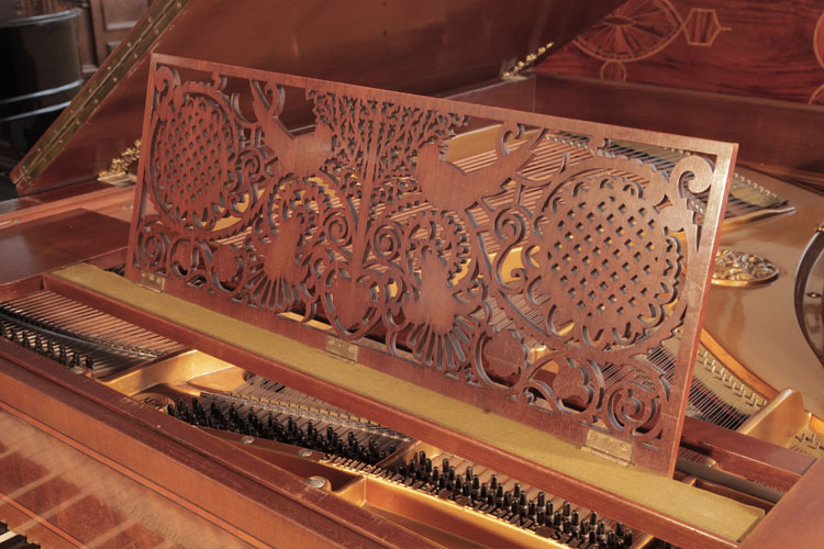 Schiedmayer  music desk   in an openwork Arts and Crafts design featuring folkloric motifs including stylised birds, flowers, hearts, arabesques and a central tree 