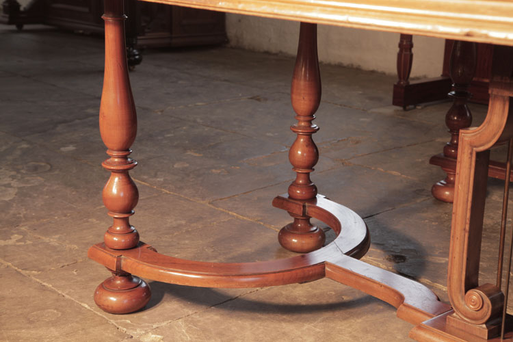 Bluthner eight baluster legs with bun feet are fixed to a serpentine cross stretcher