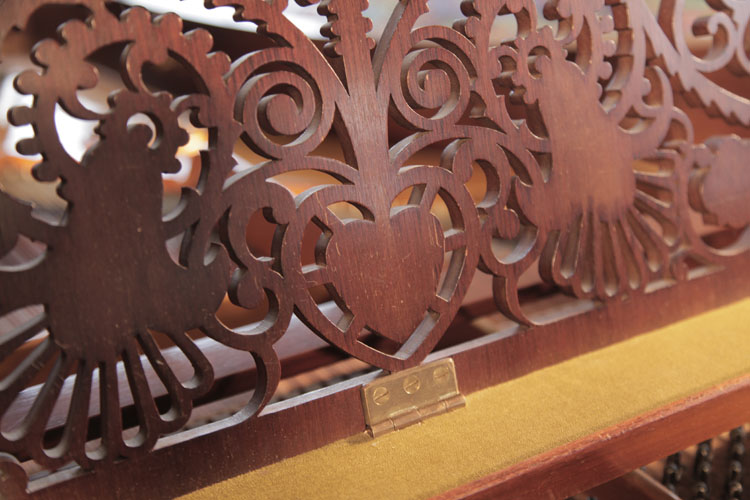 Schiedmayer    music desk detail of a heart surrounded by arabesque scrolls