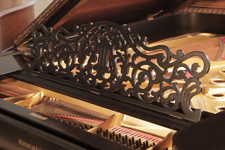 Steinway  Model B  piano music desk in an openwork arabesque design with central lyre motif