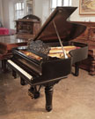 Piano for sale. Reconditioned, 1900, Steinway Model B grand piano with a satin, black case and fluted, barrel legs. Piano has a three-pedal lyre and an eighty-eight note keyboard. 